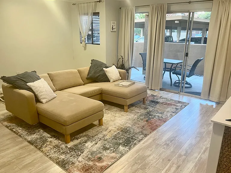 Oversized living room with space to add kitchen table. Comes with blackout curtains. Not furnished; staged for photos.