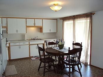 The kitchen includes a gas range, electric oven, dishwasher and refrigerator.