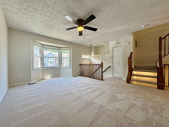 Large living room with bay window, coat closet, and bathroom all on the main floor.