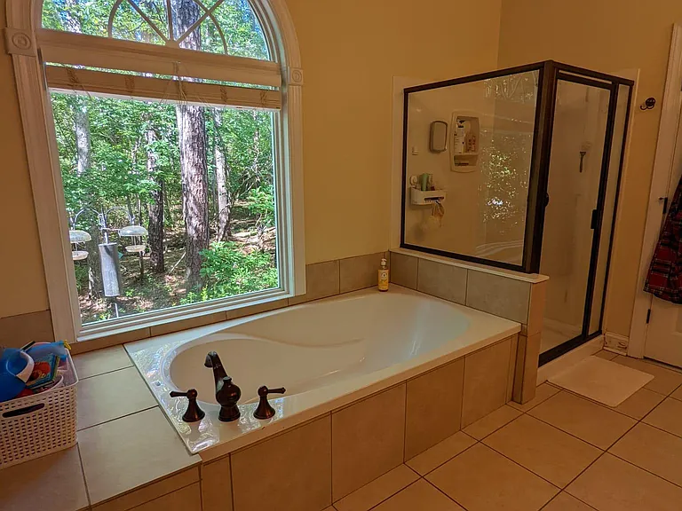Master bathroom with separate soaking tub and shower stall. Toilet secluded in water closet. Large walk-in closet is off the master bathroom.