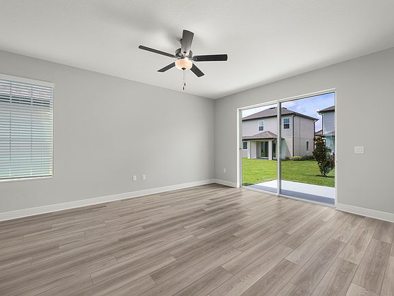 The family room room with a sliding door to the back patio