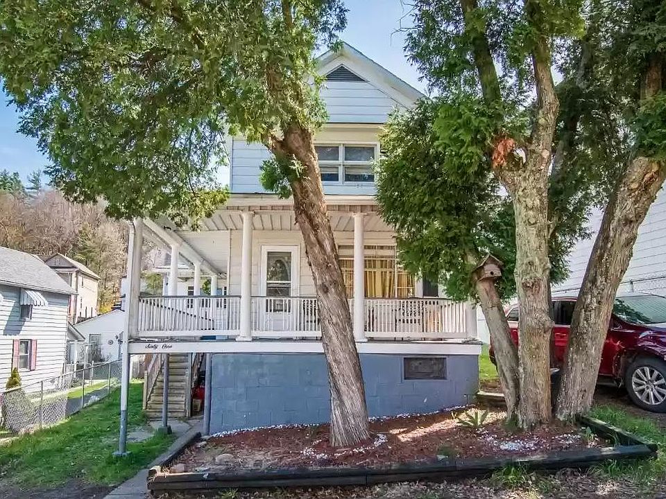 Off street parking, wrap around porch and trees make for an inviting entrance to your new home