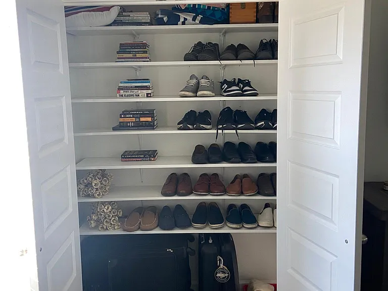 Master bedroom second closet with custom-built shelves, perfect for shoes and accessories!
