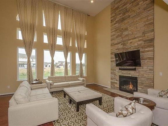 WALL OF WINDOWS AND BEAUTIFUL STONE GAS FIREPLACE HARDWOOD THROUGHOUT THE 1ST FLOOR