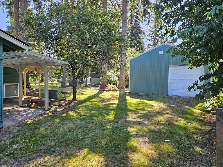 View of backyard and detached garage looking E