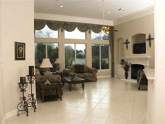The family room is open to the kitchen and breakfast area. It features a dramatic wall of windows an
