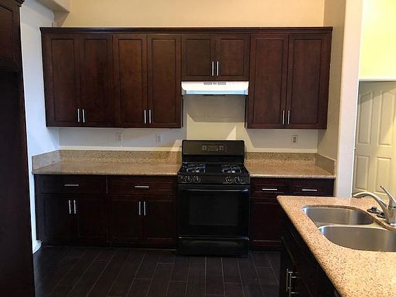 Beautiful granite counters and wood cabinetry with stylish pulls