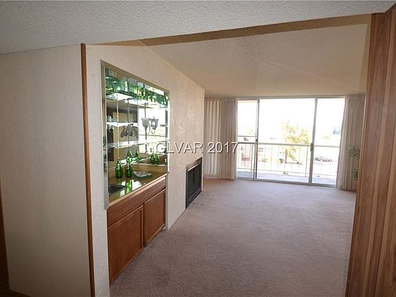 Entrance to spacious living room area with its own balcony.
