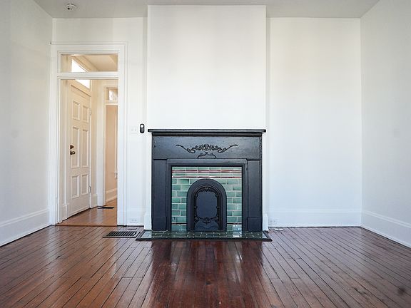 Large living room with old-world charm and plenty of space for furniture in many configurations.