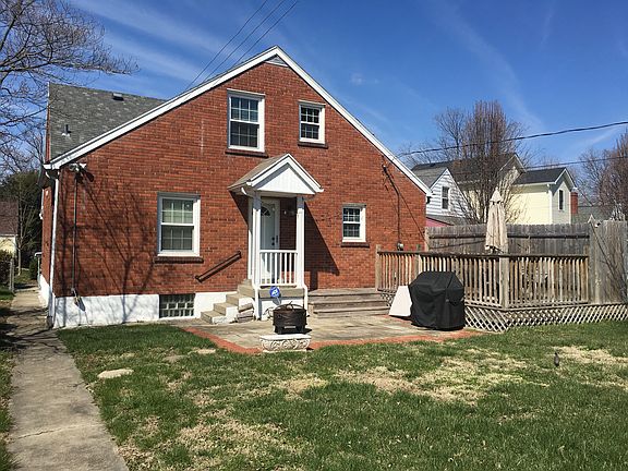Back of the home with covered entrance and deck. Security lights on back of house