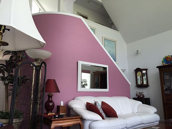 Living room w/curved stairs