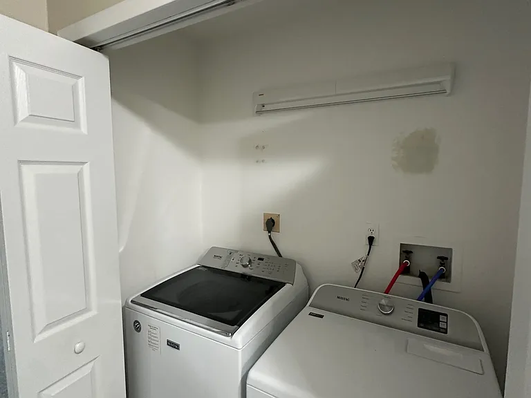 Washer and dryer on second floor, located in hallway.