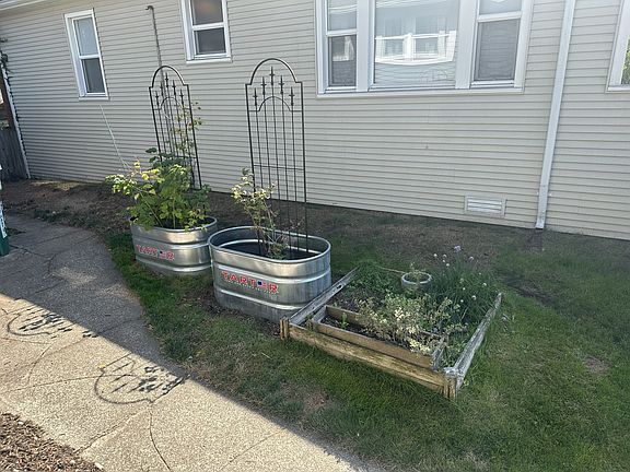 Southwest exposure raised garden with herbs and raspberries.