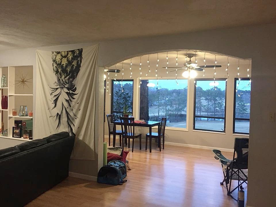 Livingroom into sunroom with panoramic view of golf course and pond