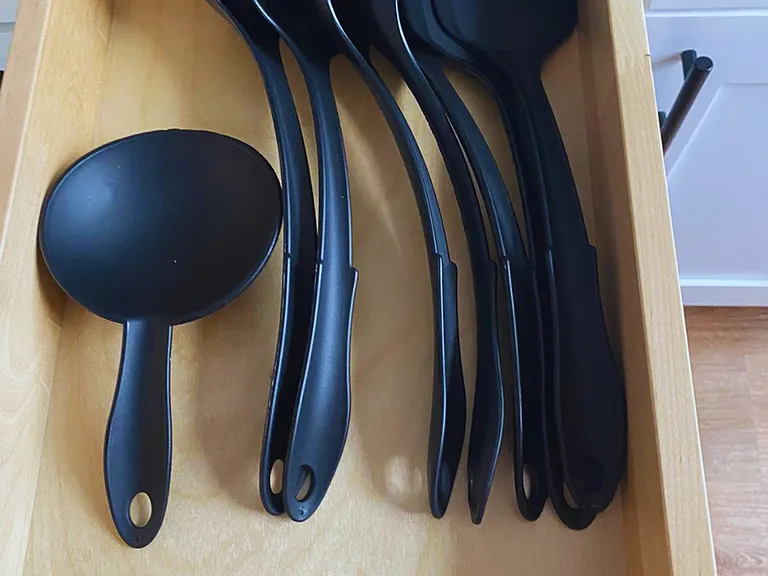 One cabinet includes cooking utensils for everyday use.
