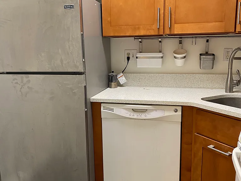 Separate modern kitchen. Quartz counter. Freezer top refrigerator. dishwasher. Hanging accessories to keep your cooking tools at hand.