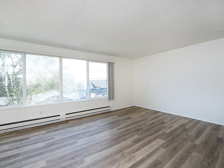 Spacious Tacoma living room with natural light and modern flooring. Spacious Tacoma living room with natural light and modern flooring.
