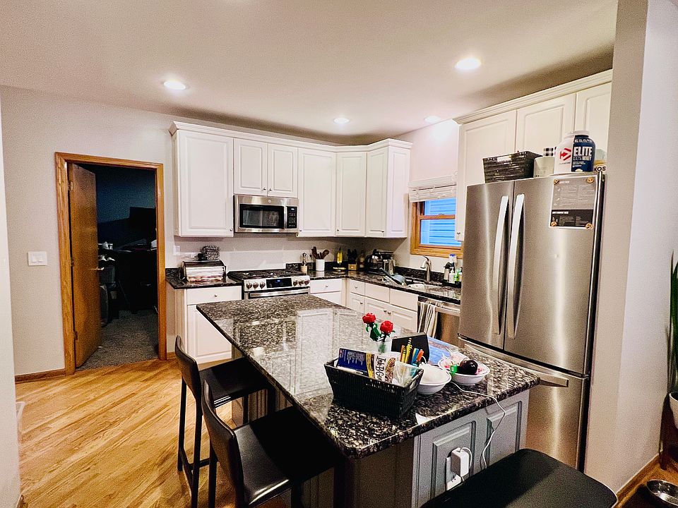 Kitchen features high-end upgraded gas stove with 6 burners including griddle burner and double oven, and over-the-range microwave, garbage disposal, extra large capacity refrigerator with fingerprint-resistant coating, & dishwasher w/stainless steel tub
