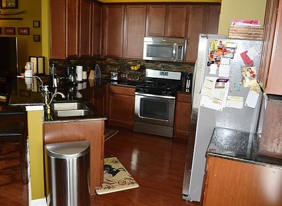 Kitchen opens to living area. Beautiful granite countertops and new backsplash.