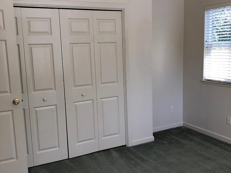 Bedroom #2 contains a large, double- door closet, two window areas and a ceiling fan.