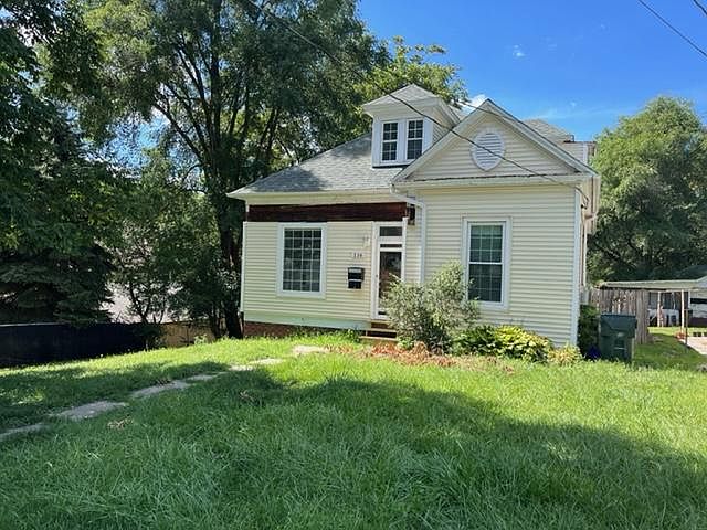 Charming pale yellow exterior and spacious lot and brand new windows
