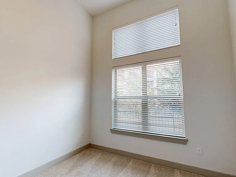 Spacious apartment Bedroom with Carpet Flooring.