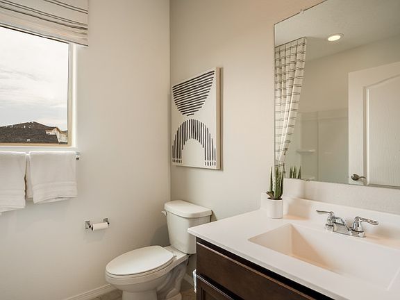 Secondary bathroom separates bed 2 and 3 and features a shower tub combo.