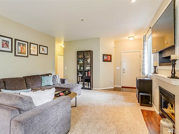 The spacious living room opens to the hallway where you'll find three bedrooms.