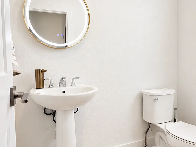 Downstairs Powder Room with LED-Lit Framed Vanity Mirror