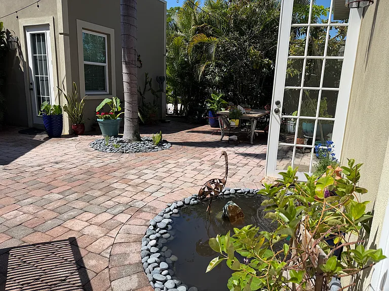 Enjoying sitting on the patio in a lush landscape and calming sounds from our pond.