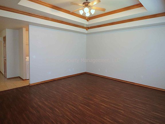 Living room with high ceiling and ceiling fan