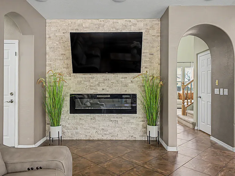 In-wall fireplace with mounted television.