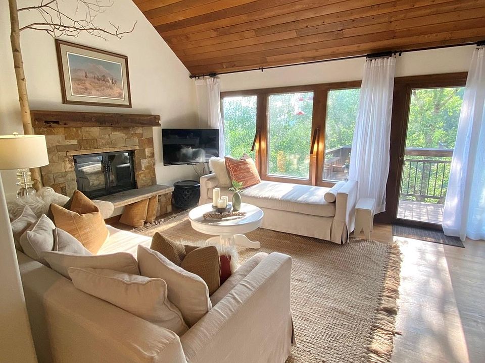 Living Room with west facing window. The entrance to the deck is straight ahead. Dining room is off to the right.