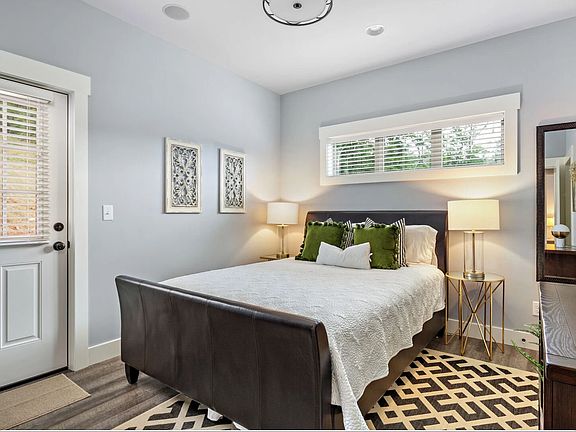 2nd en-suite Bedroom has equal access to the back deck and hot tub as well as private entry to the hall bath and a walk-in closet.
