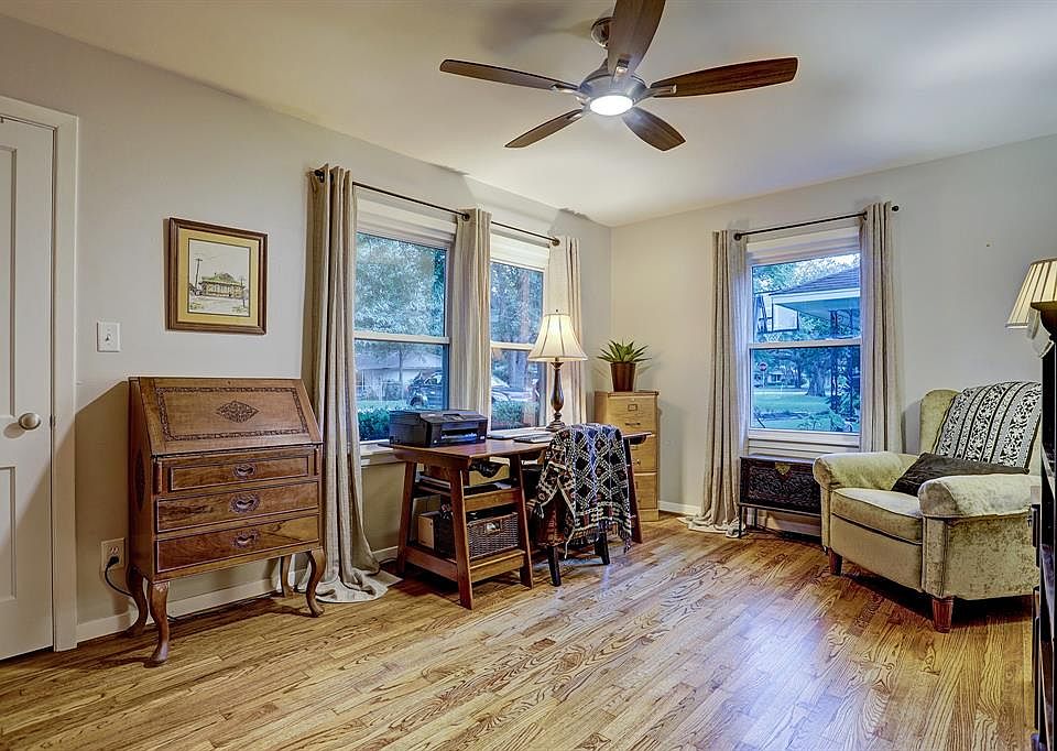 Front bedroom view with gleaming rich original oak flooring, redone by the owners in 2017. This rare condition of flooring exists throughout. Natural light blesses this home from all angels. Large closet, updated lighted ceiling fan and soothing pale