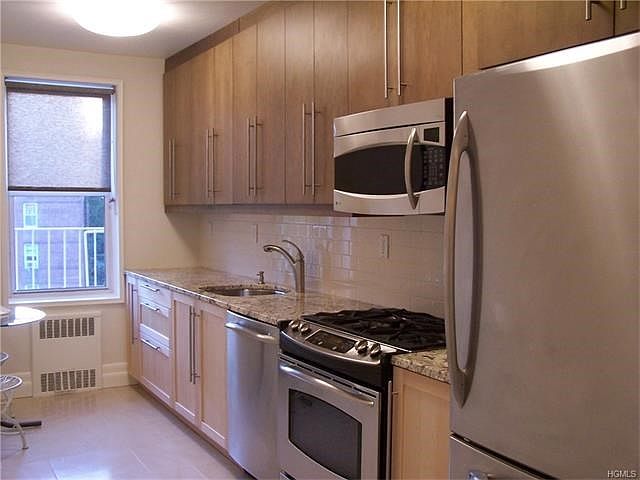 Modern kitchen renovated in 2009 and updated again in 2016 exemplifies this one-of-a-kind two-bedroom co-op.