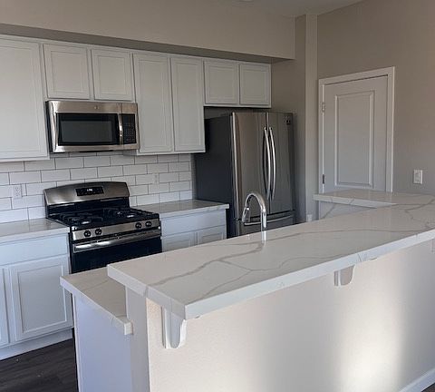 Spacious kitchen with refrigerator, gas stove and microwave. Spacious pantry and cabinets.