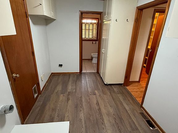 Utility room with additional 1/2 bath off the garage / kitchen.