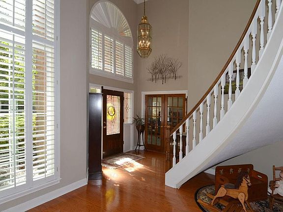 The elegant 2-story entry is graced by the formal dining room and study.