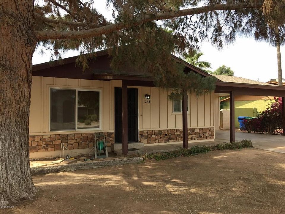 Front of home with large tree