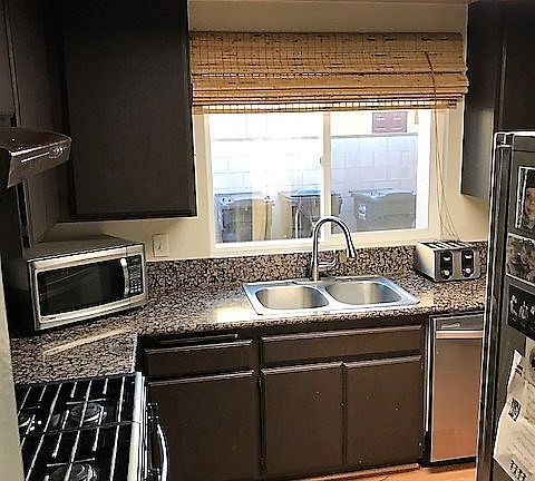 Kitchen looking in from dining area. Nice granite counter top, gas range, stainless sink, and stainl