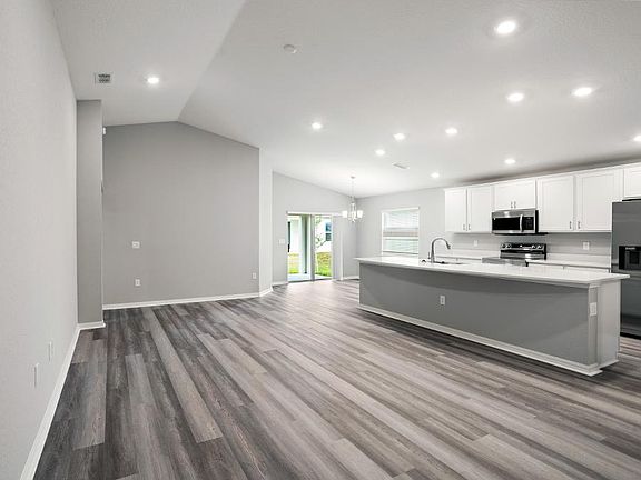 Enjoy a sunny, open living area with volume ceilings - Paisley by Highland Homes