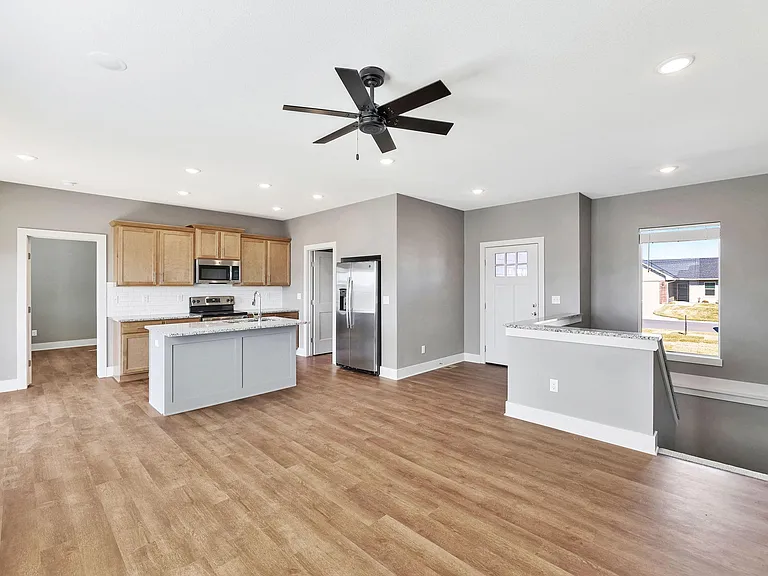 LR, Kitchen with eating bar, Dining Room and open stairwell.