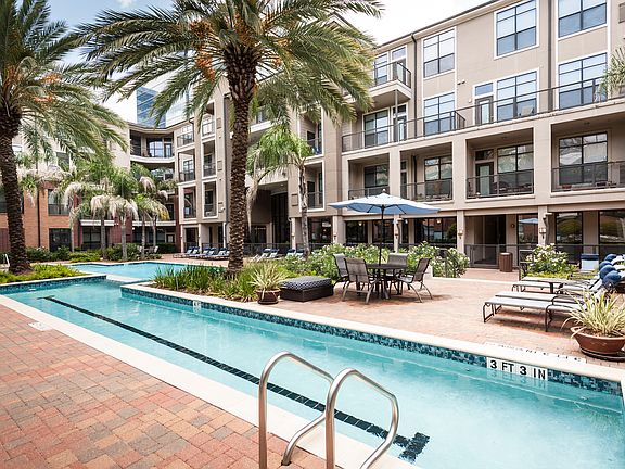 Resort-Inspired Pool with Sun Ledge, Lap Pool, and Waterfall.