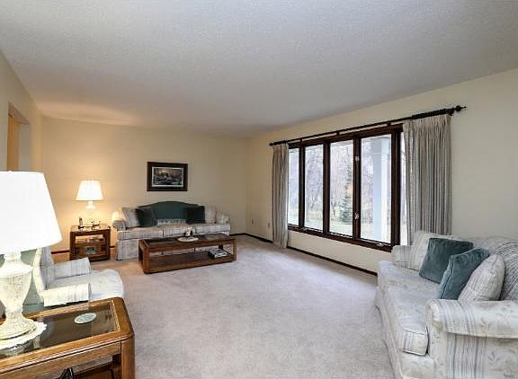 The open floorplan flows from the foyer to kitchen/dining and living room areas.  Large windows let in tons of natural light.