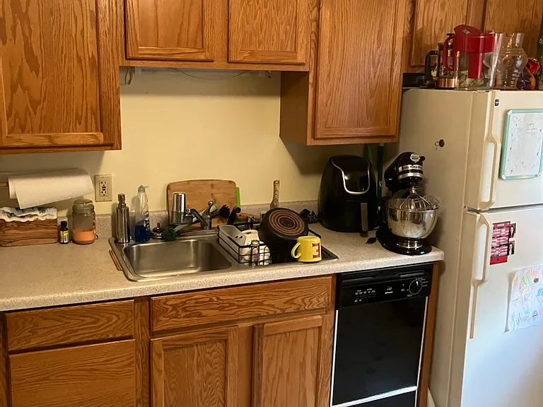 Kitchen, stainless steel sink, disposal, dishwasher, freezer, and refrigerator