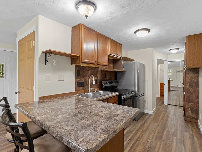 Renovated kitchen with island and stainless steel appliances