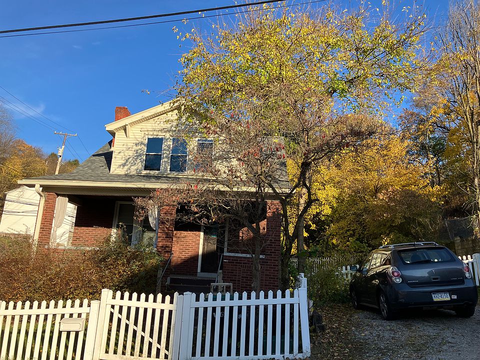 Front of home. This large tree out front has since fallen down in the latest storm. Parking available for two cars on property.