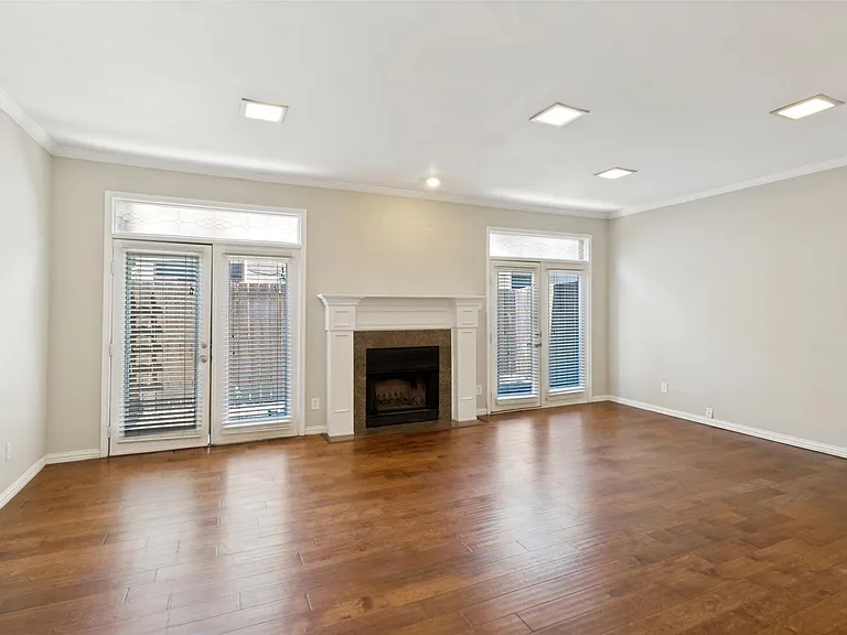 Wood floors with wood burning fireplace. Powder bath located under the stairs.