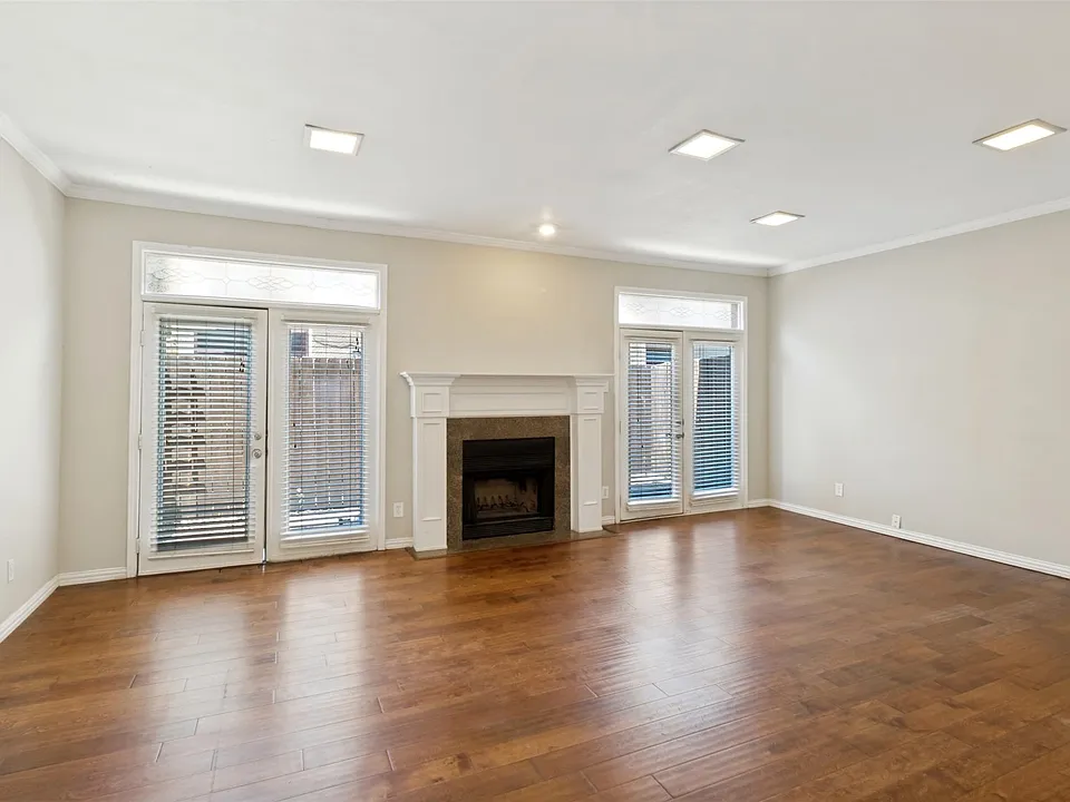 Wood floors with wood burning fireplace. Powder bath located under the stairs.